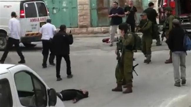 This still grabbed from video released by Isreali human rights group, B’Tselem, on March 24, 2016 shows Israeli soldier, Elor Azaria, aiming his weapon before shooting dead already-subdued Palestinian, Abed al-Fatah al-Sharif, in the West Bank city of al-Khalil (Hebron). (Photo by AFP)
