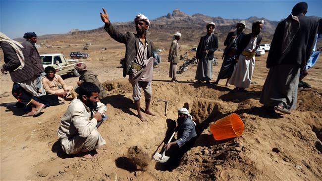 Yemenis prepare to bury a victim of a air raid