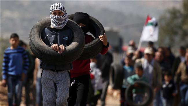 Palestinian protesters carry tires during a weekly demonstration against the expropriation of Palestinian land by Israel in the town of Kfar Qaddum, near Nablus, in the occupied West Bank on February 24, 2017. (Photo by AFP)
