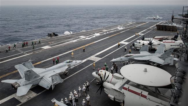 This file photo taken on June 15, 2014 shows aircrafts pictured on the flight deck of the US nuclear-powered aircraft carrier USS George Washington off the coast of Hong Kong. (Photo by AFP)