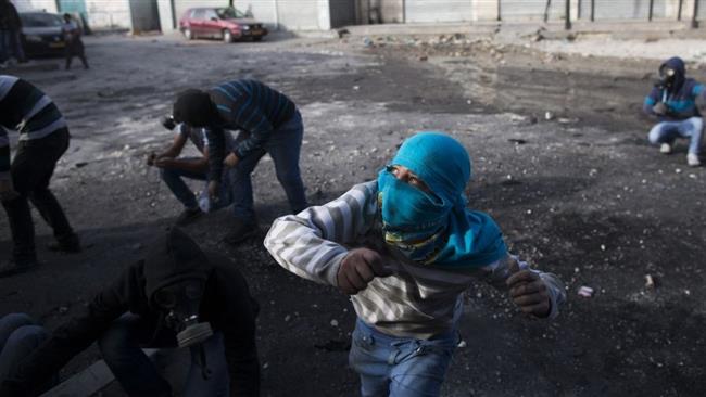 Palestinian youth throw stones during clashes with Israeli military forces at Shuafat refugee camp in the occupied Jerusalem al-Quds.