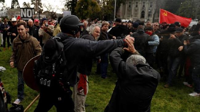 A demonstrator in support of President Trump fires pepper spray at a group of counter-protesters during a pro-Trump rally in Berkeley, California on March 4, 2017 