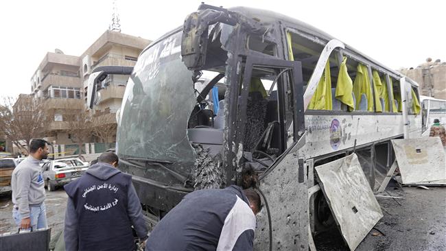Syrian forensics examine a bus at the scene of a bombing following twin attacks targeting Shia pilgrims in Damascus