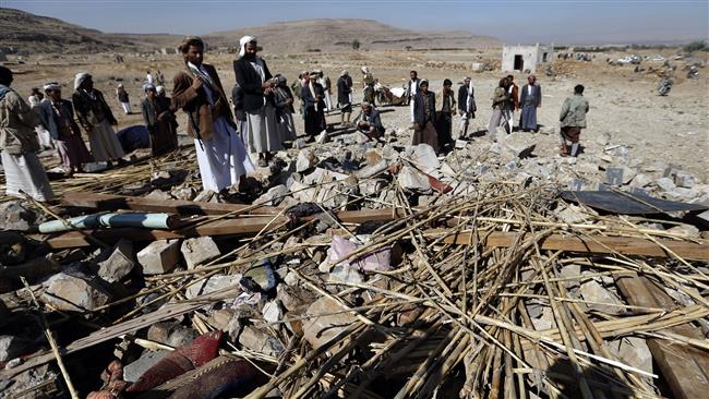 Yemeni men check the site of an air raid that hit a funeral reception in the Arhab district, 40 kilometers north of the capital Sana