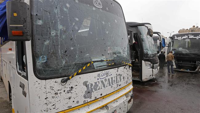 A general view shows damaged buses at the scene of a bombing following twin attacks targeting Shia pilgrims in Damascus