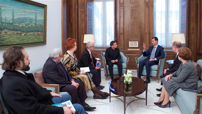 Syrian President Bashar al-Assad (3rd R) speaks with Deputy Chairman of the European Parliament’s Committee on Foreign Affairs Javier Couso (5th L) in the capital Damascus, on March 12, 2017. (Photo by SANA)
