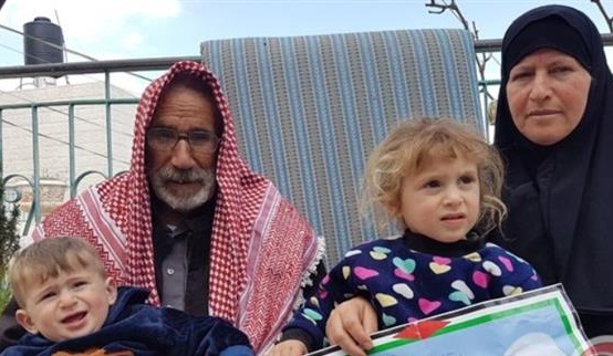 The photo shows the parents of Palestinian Fadi al-Qanbar and two of his children.
