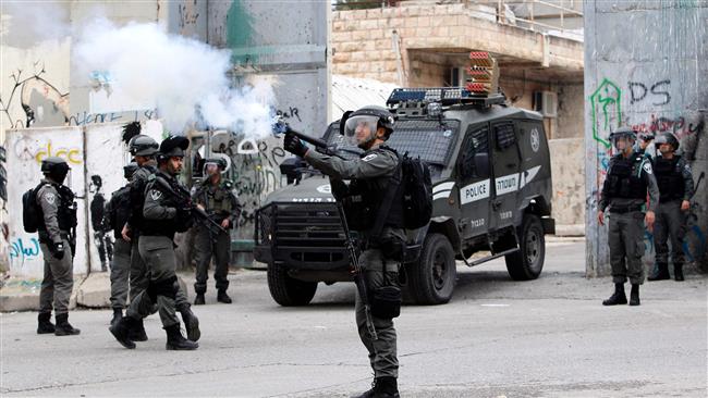 An Israeli soldier fires tear gas towards Palestinian protesters during clashes in the occupied West Bank city of Bethlehem on March 22, 2017. (Photo by AFP)
