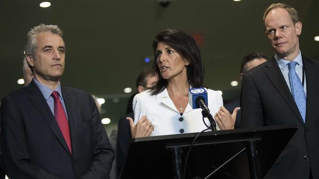 Flanked by French Deputy Representative to the United Nations Alexis Lamek (L) and British Representative to the United Nations Matthew Rycroft (R), US Ambassador to the United Nations Nikki Haley speaks to reporters at the UN headquarters, March 27, 2017, in New York City. (Photo by AFP)
