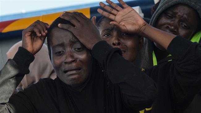 Refugee women crying after being saved in the Mediterranean Sea