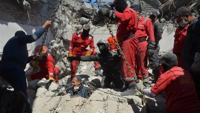 Iraqi firefighters look for bodies buried under the rubble, of civilians who were killed after an airstrike targeting ISIL terrorists prompted a massive explosion in Mosul, Iraq, on March 27, 2017. (Photo by Reuters)
