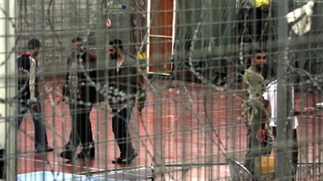 Palestinian prisoners walk at the yard of the Israeli prison of Megiddo