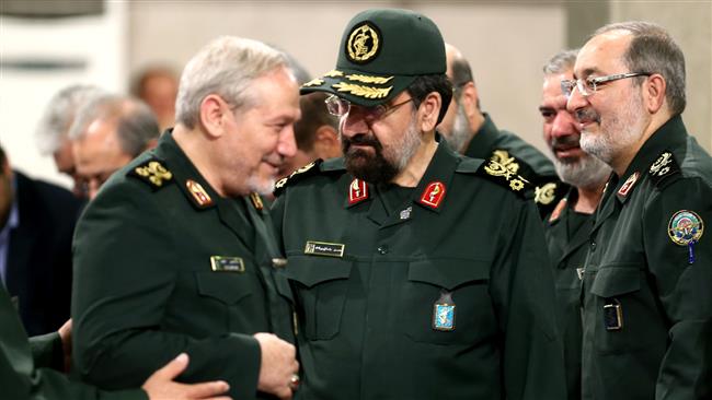 Former IRGC commanders Mohsen Rezaei (C) and Yahya Rahim Safavi (L) talk on the sidelines of an event in Tehran.