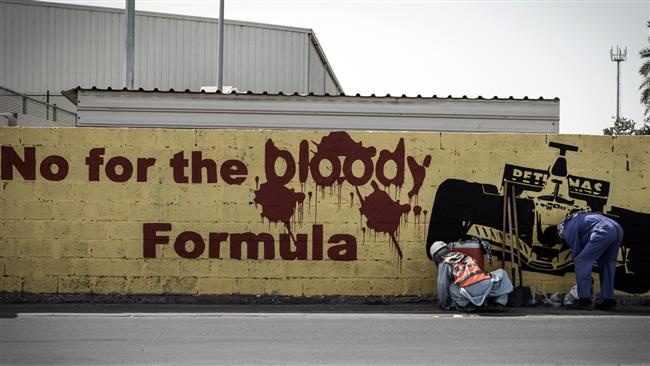 A mural depicting a racing car and reading, "No for the bloody Formula" in Bahrain
