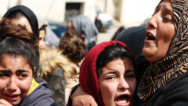 Relatives of Palestinian teenage boy Muhammad Mahmoud Ibrahim al-Hattab mourn during his funeral at the al-Jalazun refugee camp, near the West Bank city of Ramallah