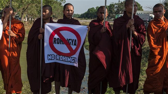 Anti-Rohingya Buddhist monks and supporters rally outside Yangon’s Thilawa port as the Malaysian ship carrying relief aid for Rohingya Muslim minority arrives