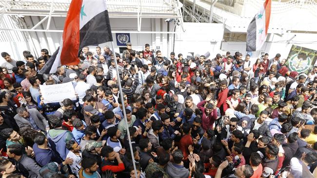 Syrian protesters take part in a demonstration outside the United Nations office in Damascus on April 11, 2017, to denounce Washington’s recent missile strike.