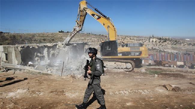 Israeli army bulldozer pulls down the Palestinian homes