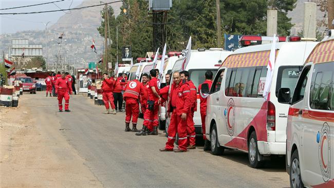 Syrian Red Crescent ambulances stand in waiting to enter the militant-held town of Zabadani, northwest of Damascus, on April 12, 2017. (Photo by AFP)

