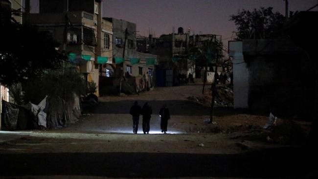 Palestinians walk on a road during a power cut in Beit Lahiya in the north of Gaza Strip. (Photo by Reuters)
