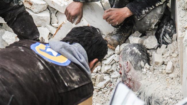 Syrian civil defense volunteers attempt to rescue a body as they dig through the rubble of a mosque following an airstrike on a mosque in the village of Jineh in Aleppo province, March 17, 2017. (Photo by AFP)
