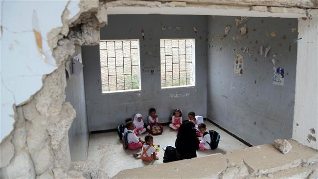 Yemeni students study in a classroom on March 15, 2016, which was damaged in a Saudi air strike. (Photo by AFP)
