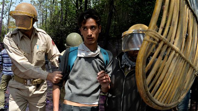 Indian government forces arrest a Kashmiri student during clashes in central Srinagar