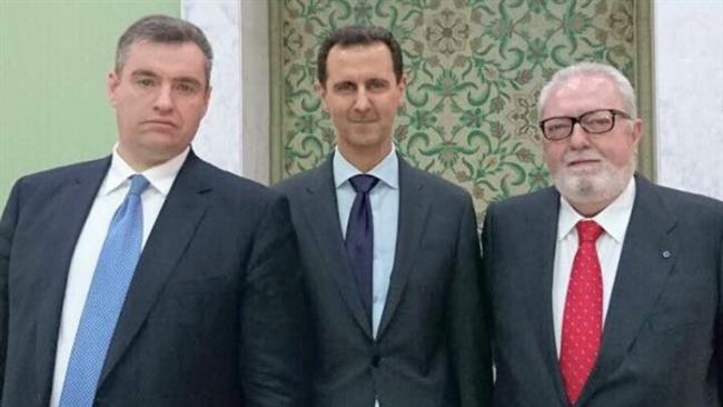 Pedro Agramunt (R) is seen next to Syrian President Bashar al-Assad (C)
