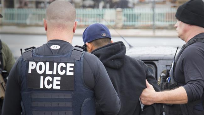 US Immigration and Customs Enforcement officers arrest a suspect during an operation in February 2017. (Photo by AP)
