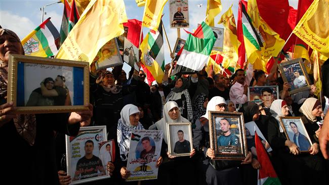 Palestinian protesters hold pictures of their loved ones during a demonstration in the West Bank city of Ramallah in support of Palestinian prisoners on hunger strike in Israeli jails, May 3, 2017. (Photo by AFP)
