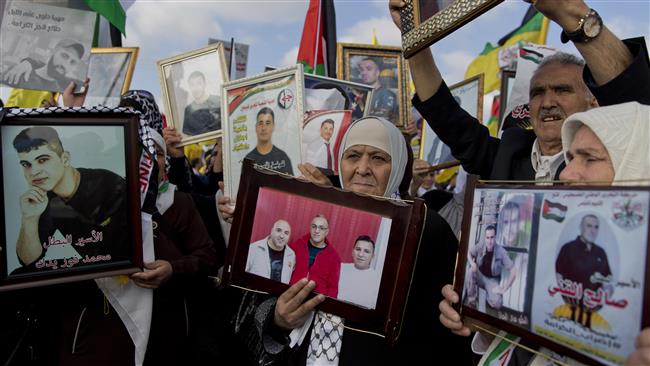 Protesters hold pictures of jailed Palestinian prisoners during a rally in support of the hunger-striking inmates in the West Bank city of Ramallah, May 3, 2017. (Photo by AP)
