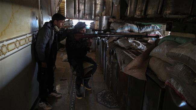 Militants from Jaysh al-Islam aim a sniper rifle in the militant-held area of Harasta, on the northeastern outskirts of the capital Damascus, on February 21, 2017. (Photo by AFP)
