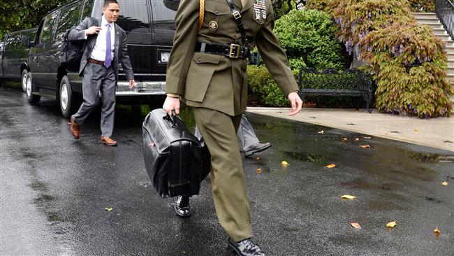 A US military officer carries the "nuclear football" at the White House