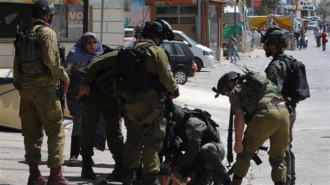 Israeli forces detain a Palestinian protester during clashes at the entrance of the occupied West Bank city of Bethlehem on May 19, 2017.
