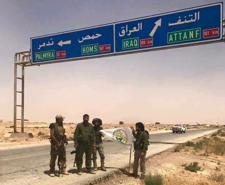 Fighters with the paramilitary troops of Hashd al-Sha’abi standing on a road on the Syrian-Iraqi border, shortly after they reached the area on May 29, 2017.
