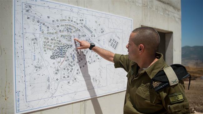 Israeli Brigadier General Einav Shalev, the head of the Ground Forces Division, shows the map of a training facility that resembles a Lebanese village, May 29, 2017.
