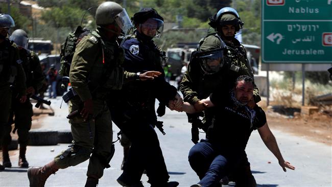 Israeli forces detain a Palestinian protester