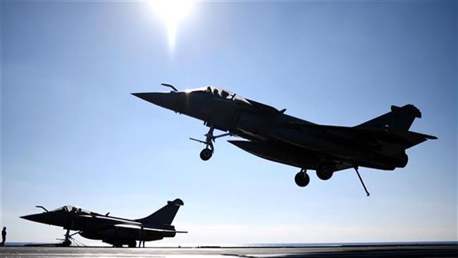 A French Rafale fighter jet lands on the deck of France