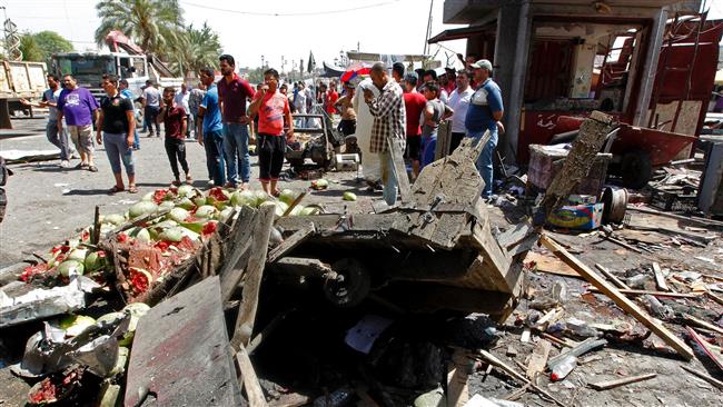 Iraqis gather at the site of a car bomb explosion near Baghdad