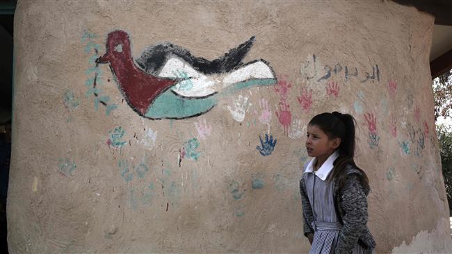 A Palestinian Bedouin schoolgirl walks at her school in the village of Khan al-Ahmar in the Israeli-occupied West Bank on February 23, 2017. (Photo by AFP)
