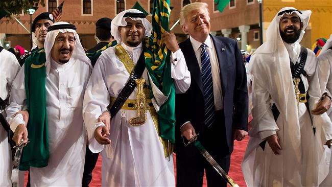 This image provided by the Saudi Royal Palace on May 20, 2017, shows US President Donald Trump (2nd-R) with a smug face doing a dance move with Saudis after closing a huge arms deal. (Photo by AFP)
