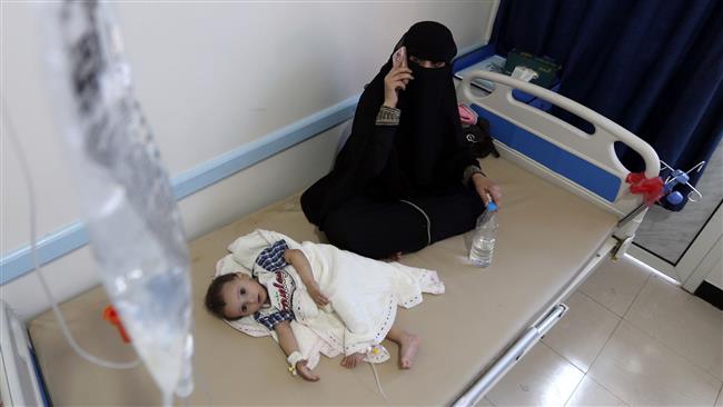 A Yemeni mother sits near her child suspected of being infected with cholera receiving treatment at a hospital in the capital Sana’a on May 25, 2017. (Photo by AFP)
