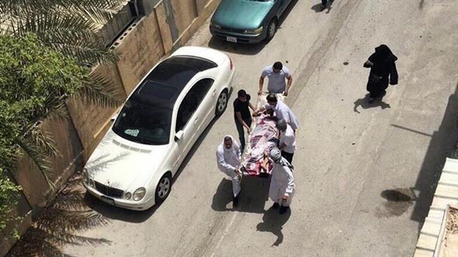 This image provided by an activist, who requested anonymity, shows people carrying a man who was injured in a raid on a sit-in in the village of Diraz, Bahrain, on May 23, 2017. (Photo by AP)
