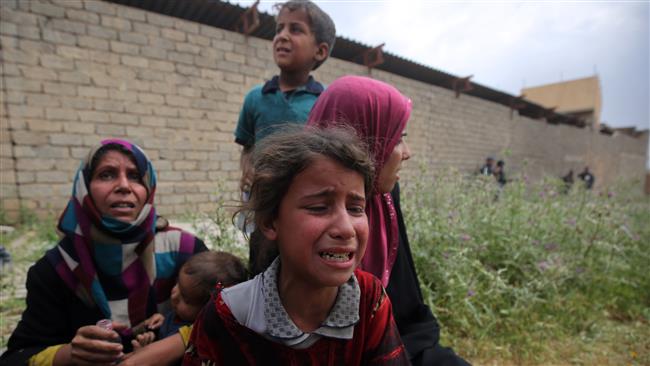 File photo shows displaced Iraqi children from the al-Haramat neighborhood, north of Mosul, react after leaving their homes as Iraqi forces advance towards the area during the ongoing offensive to retake Mosul from Daesh terrorists. (Photo by AFP)
