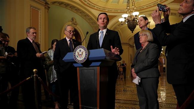 US Senator Chris Murphy along with Senate Minority Leader Chuck Schumer, Senator Ron Wyden, and Senator Patty Murray, speaks to reporters on Capitol Hill in Washington, May 9, 2017.	(Photo by AFP)
