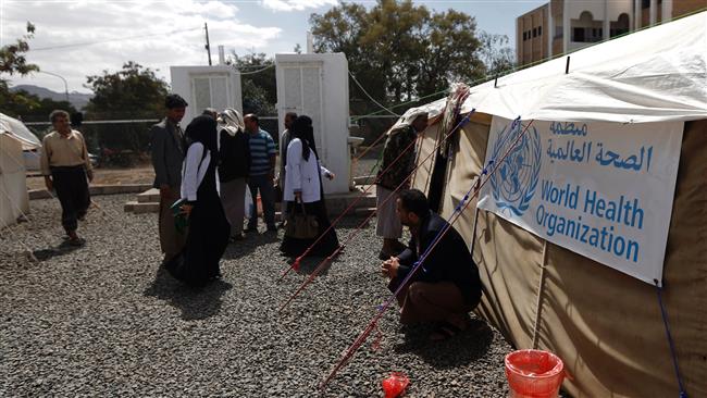 Yemenis wait outside a tent where patients infected with cholera are receiving treatment at Sabaeen Hospital in the capital Sana