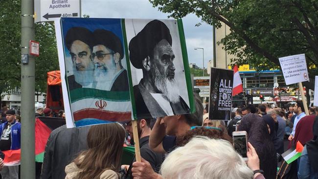 Pro-Palestinian activists rallying in Berlin, Germany, on the occasion of the International Quds Day hold up placards bearing the Iranian flag and portraits of the late founder of the Islamic Republic, Imam Khomeini, and Leader of the Islamic Revolution Ayatollah Seyyed Ali Khamenei, June 23, 2017.
