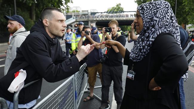 A man gestures at a woman wearing a headscarf at a demonstration organized by the far-right English Defense League (EDL) in central London on June 24, 2017. (Photos by AFP)
