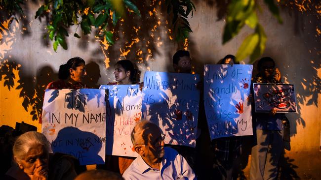 Indian protesters hold placards as they gather during a "Not in my name" silent protest at Jantar Mantar in New Delhi on June 28, 2017, following a spate of Muslim killings. (Photo by AFP)