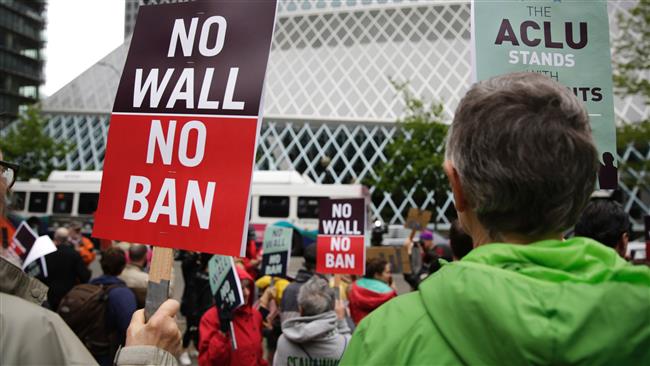 People protest outside as the 9th US Circuit Court of Appeals in Seattle prepares to hear arguments on US President Donald Trump